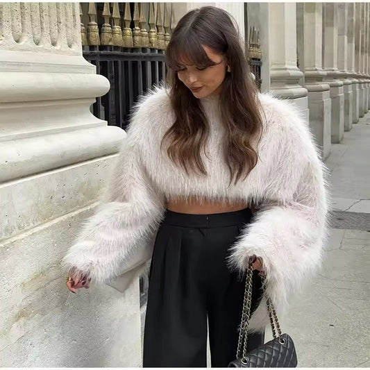 “Soft white faux fur cropped top with wide sleeves, perfect for adding a touch of elegance and cozy luxury to any outfit.”