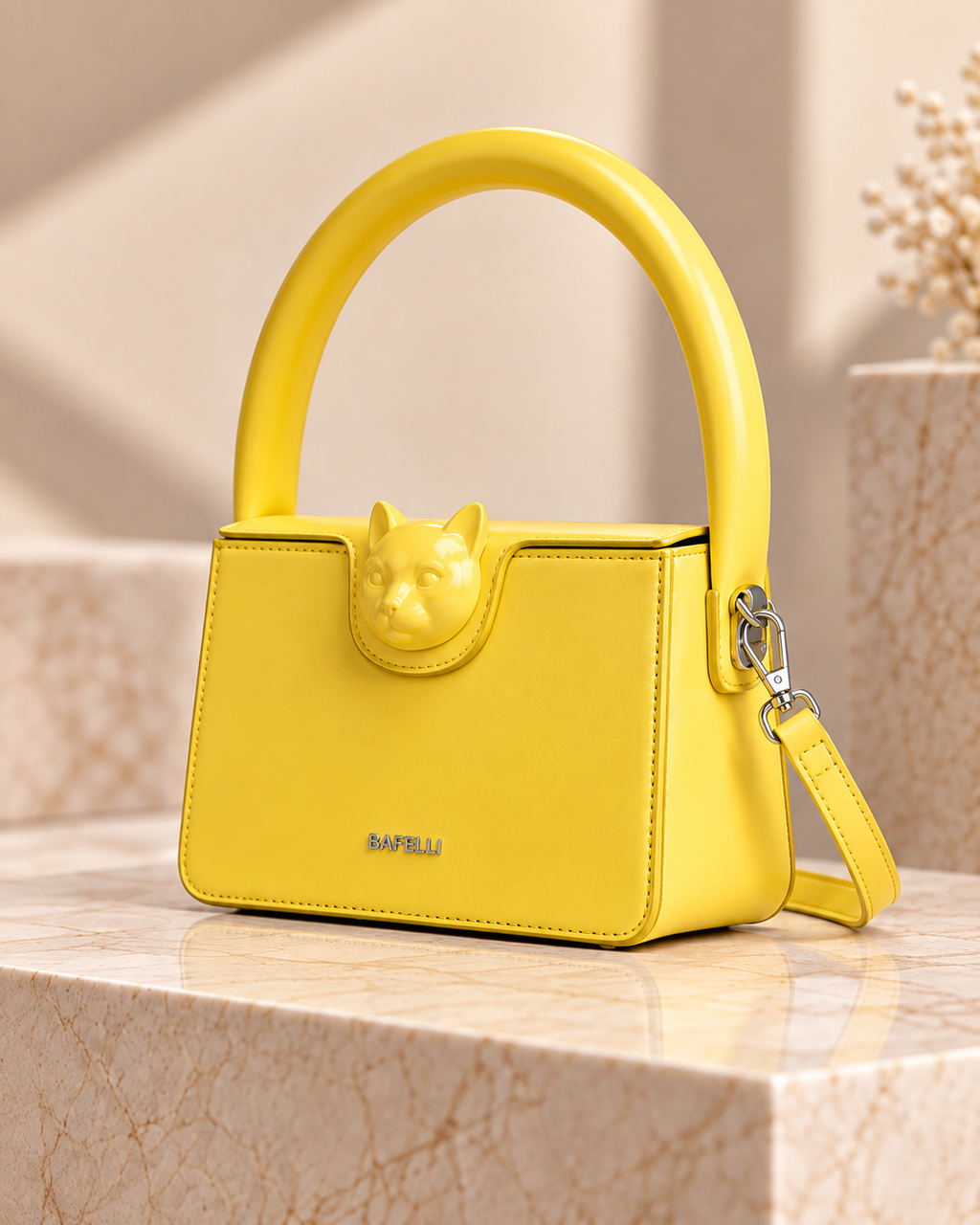 Bafelli yellow structured cowhide handbag three-quarter view with sculpted cat clasp