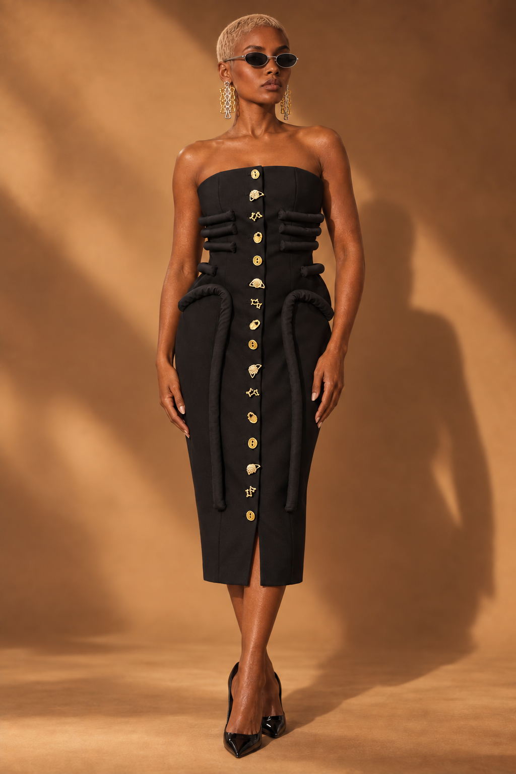Black strapless sculptural midi dress with gold charm buttons front view