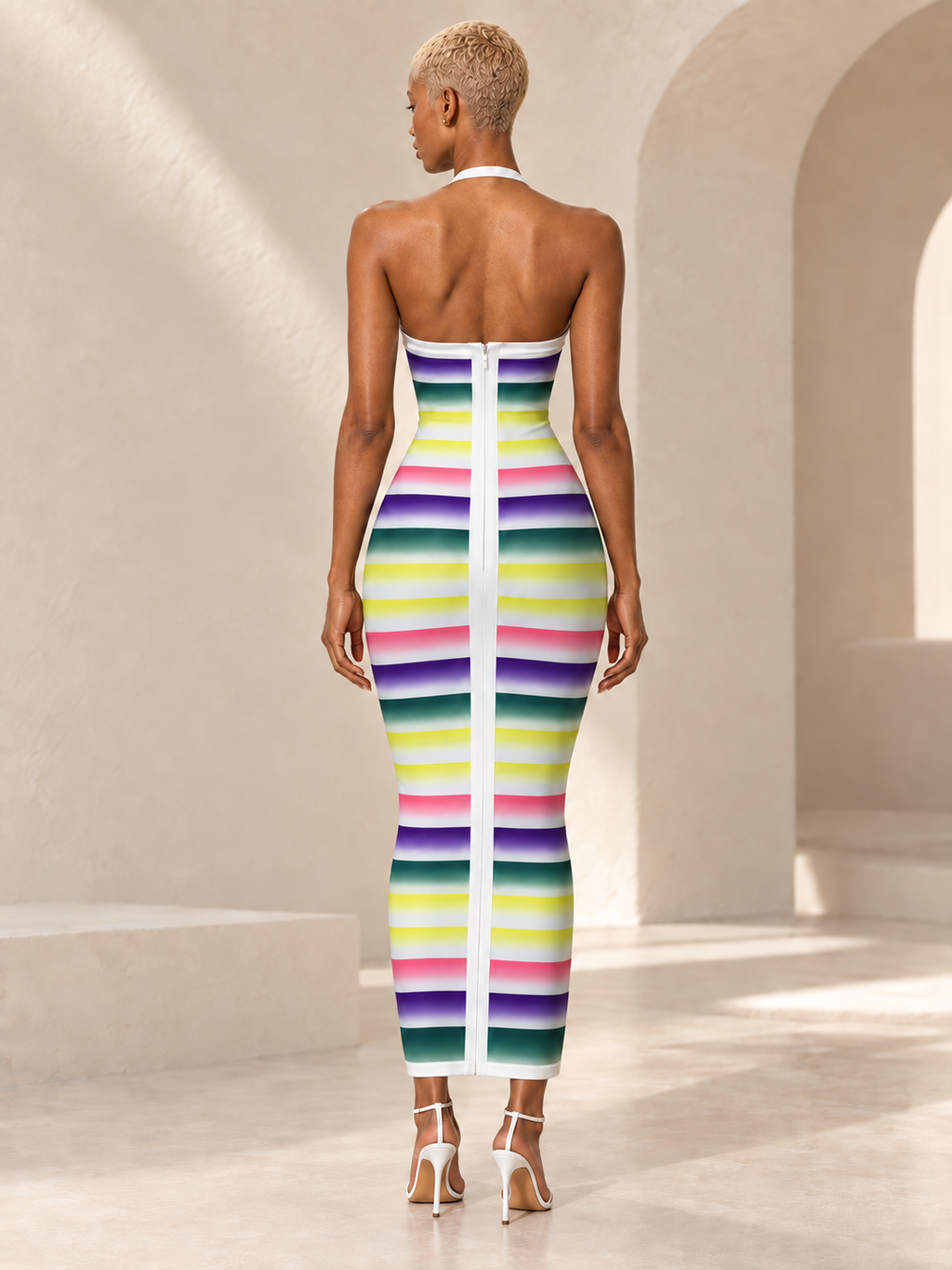 BLANC LOVE model wearing the multicolor Prism Ombré Stripe Halter Maxi Dress, back view